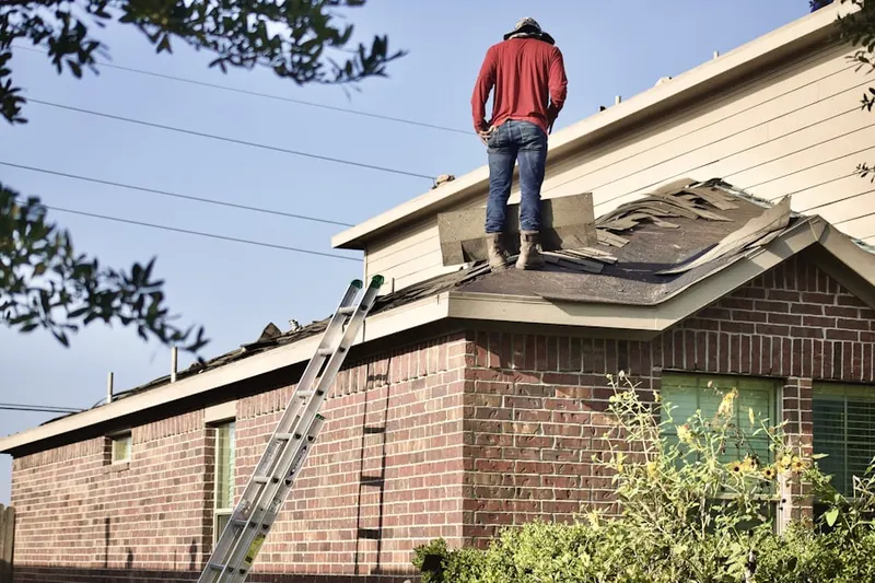 Professional roofer working on a residential roof in Ferguson